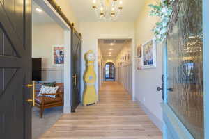 Foyer featuring light wood-finish flooring, wainscoting, and recessed lighting