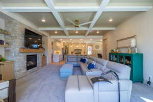 Living area featuring a coffered ceiling with recessed lighting and a ceiling fan