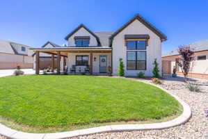 Modern farmhouse exterior with white vertical siding and dark trim