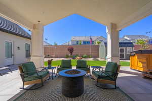 Covered patio featuring a concrete slab and overhead lighting