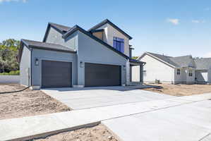 Contemporary two-story residence with a multi-textured facade featuring light blue siding and light-colored stucco elements