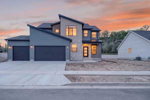 Contemporary multi-level exterior featuring a combination of siding and stone accents