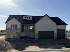 Contemporary exterior featuring a combination of stone veneer and stucco finishes