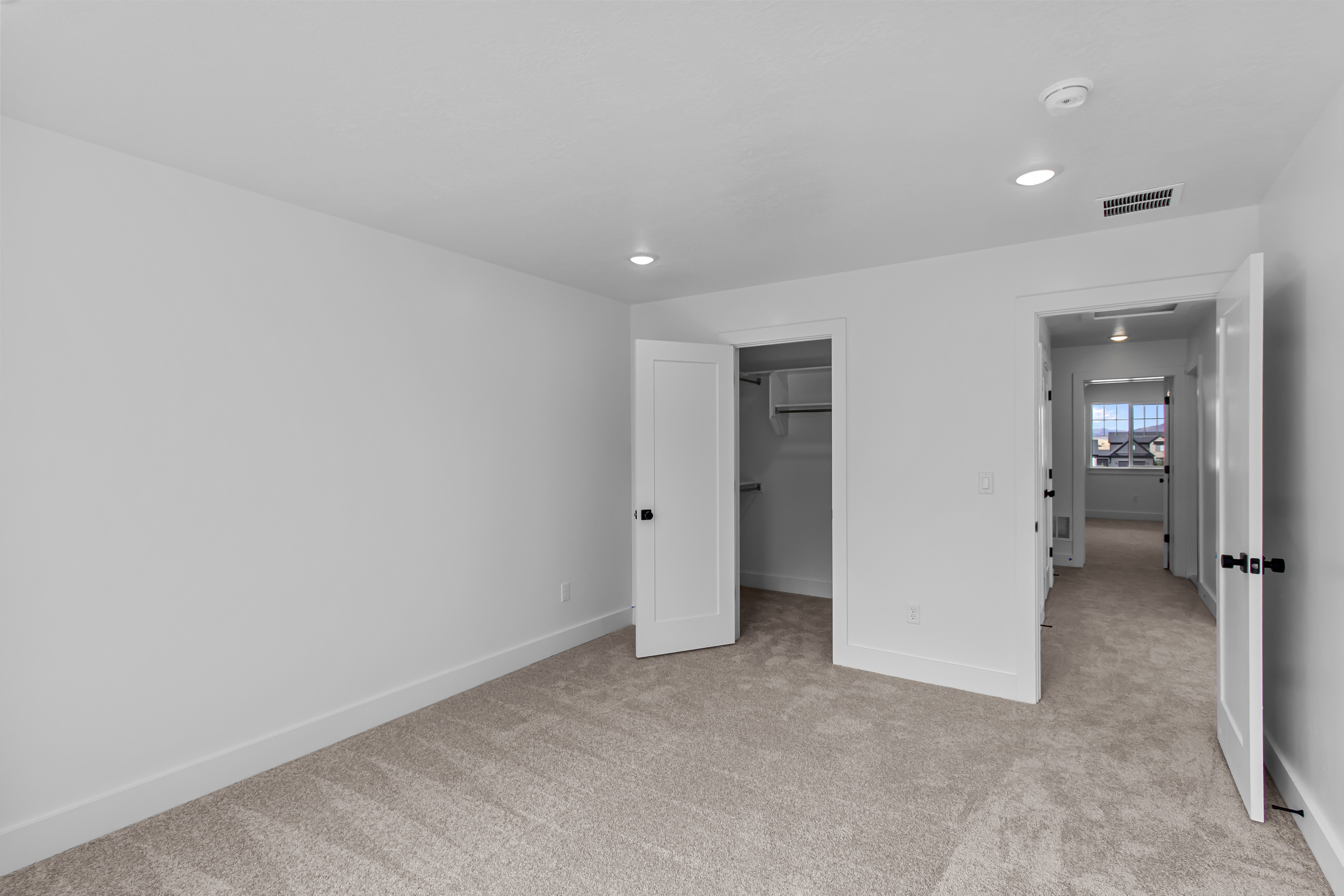 Carpeted room with recessed lighting and neutral wall tones