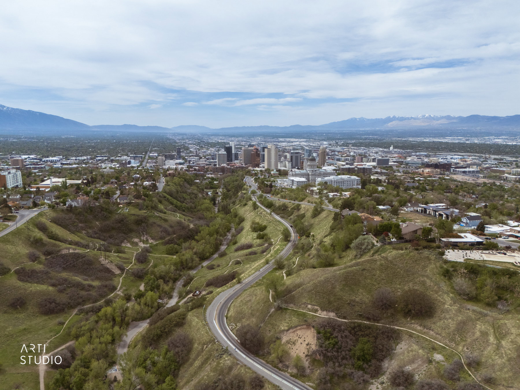 Elevated aerial perspective showcasing the Salt Lake skyline, and extensive green spaces
