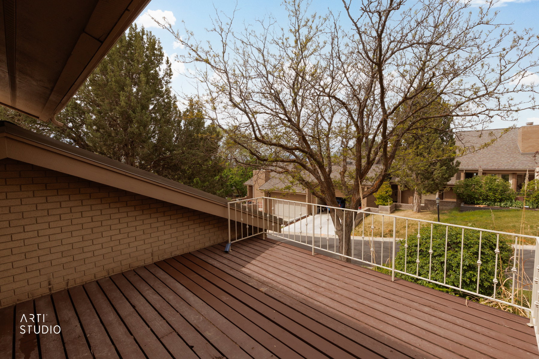 Exterior deck featuring wood-finish flooring and a white metal railing