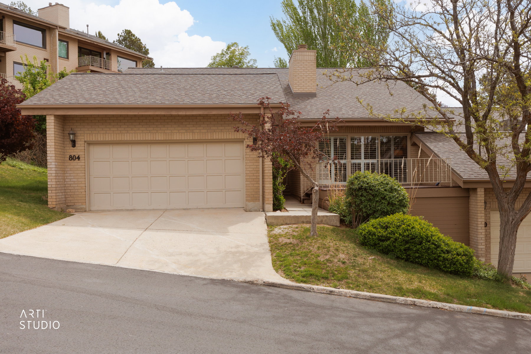 Front of property featuring walk up, front deck and two car garage.