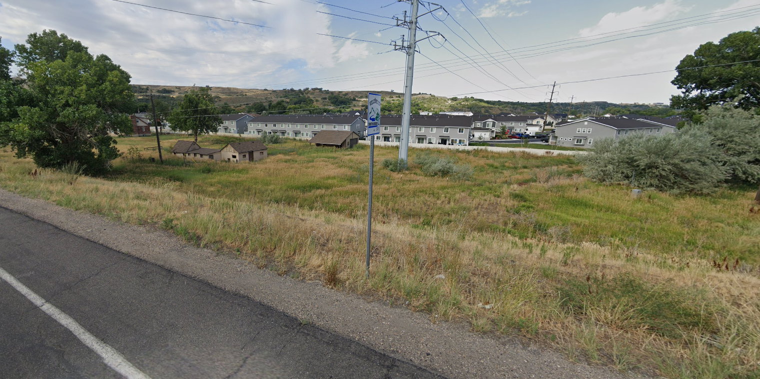 View of asphalt road featuring a residential view