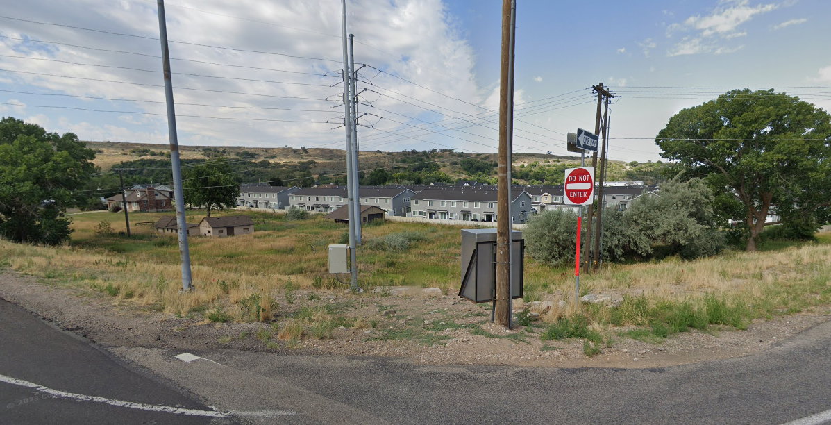 View of asphalt street with traffic signs