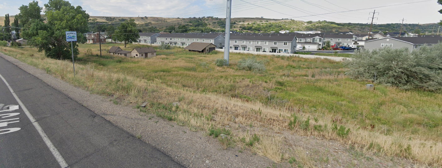 View of asphalt street featuring a residential view