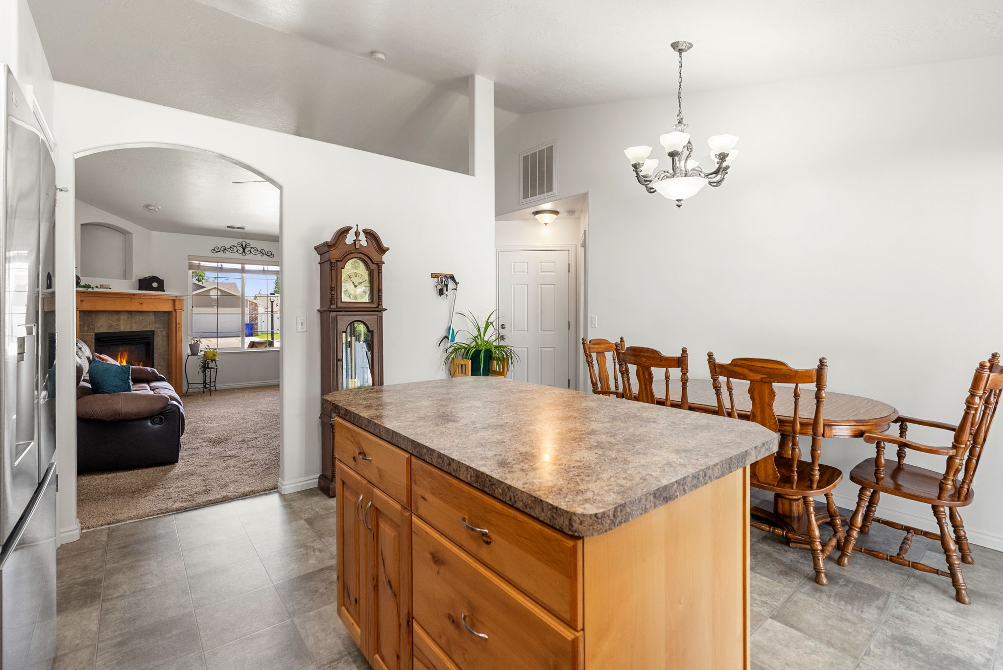 Kitchen island with wood-finish cabinetry and a neutral-toned countertop