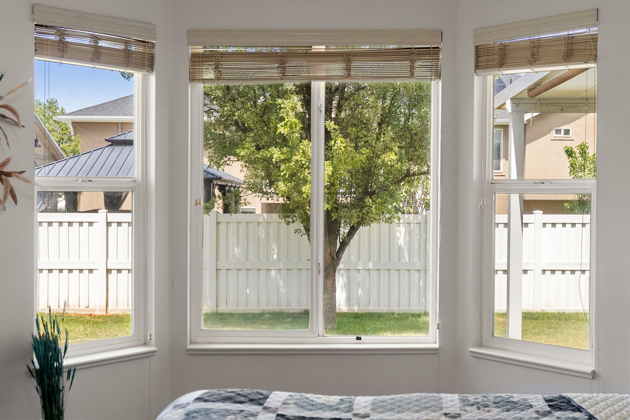 Bay window design with three double-hung windows, each featuring woven wood blinds