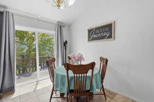 Dining area with light tile flooring and white walls