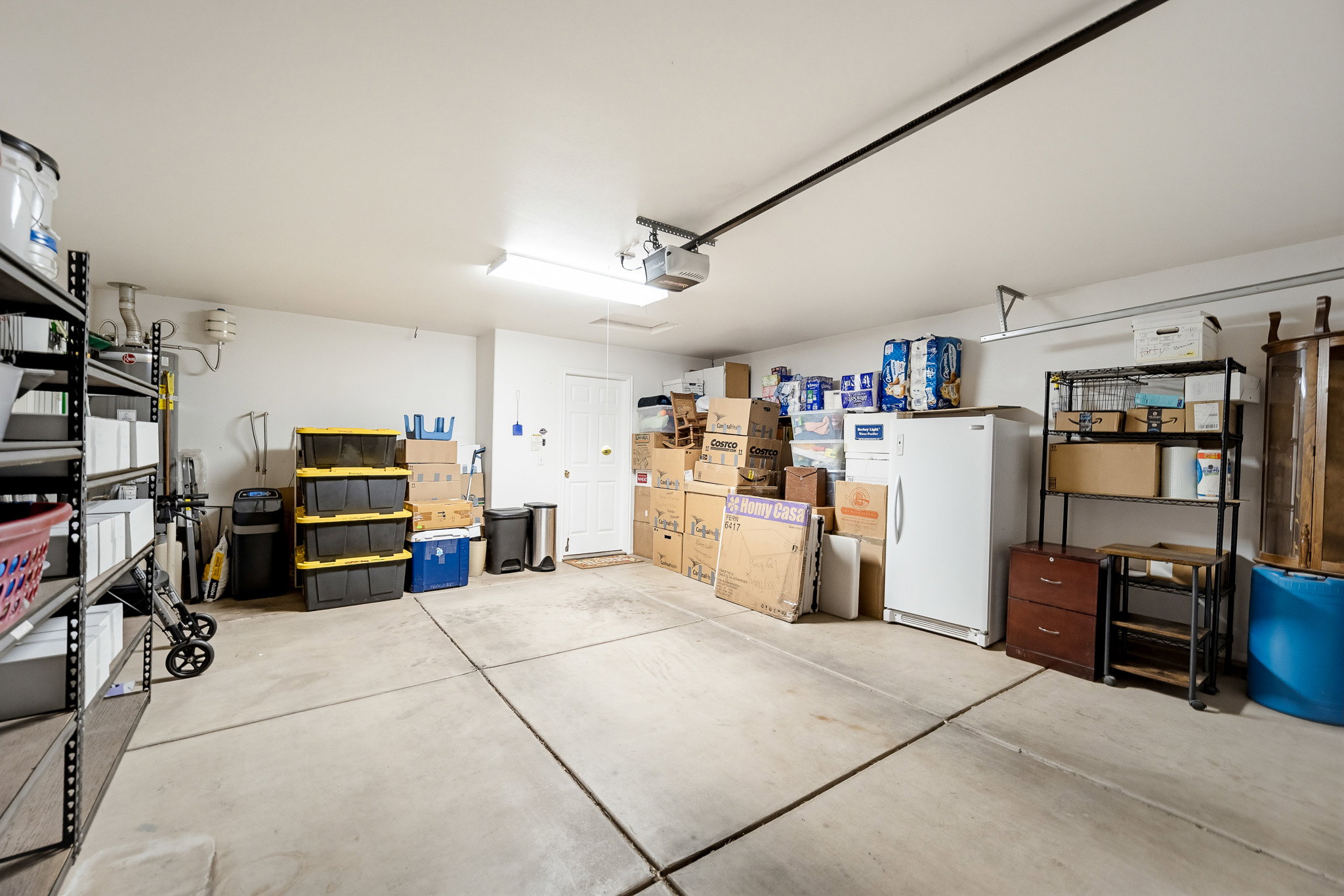 Spacious garage featuring a concrete floor, painted walls, and overhead lighting