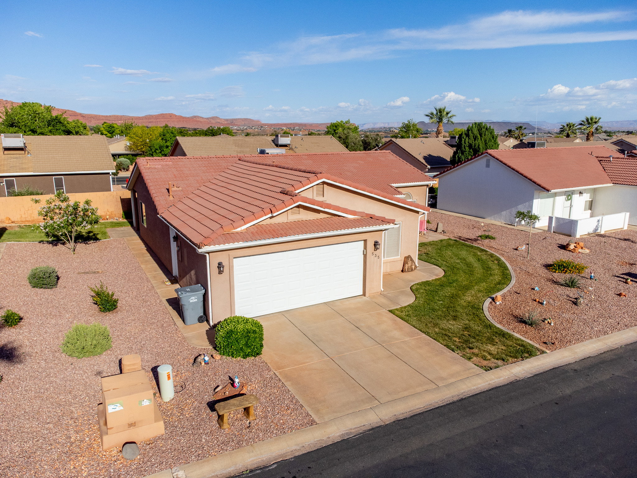 Single-story residence featuring a terracotta tile roof and an attached two-car garage