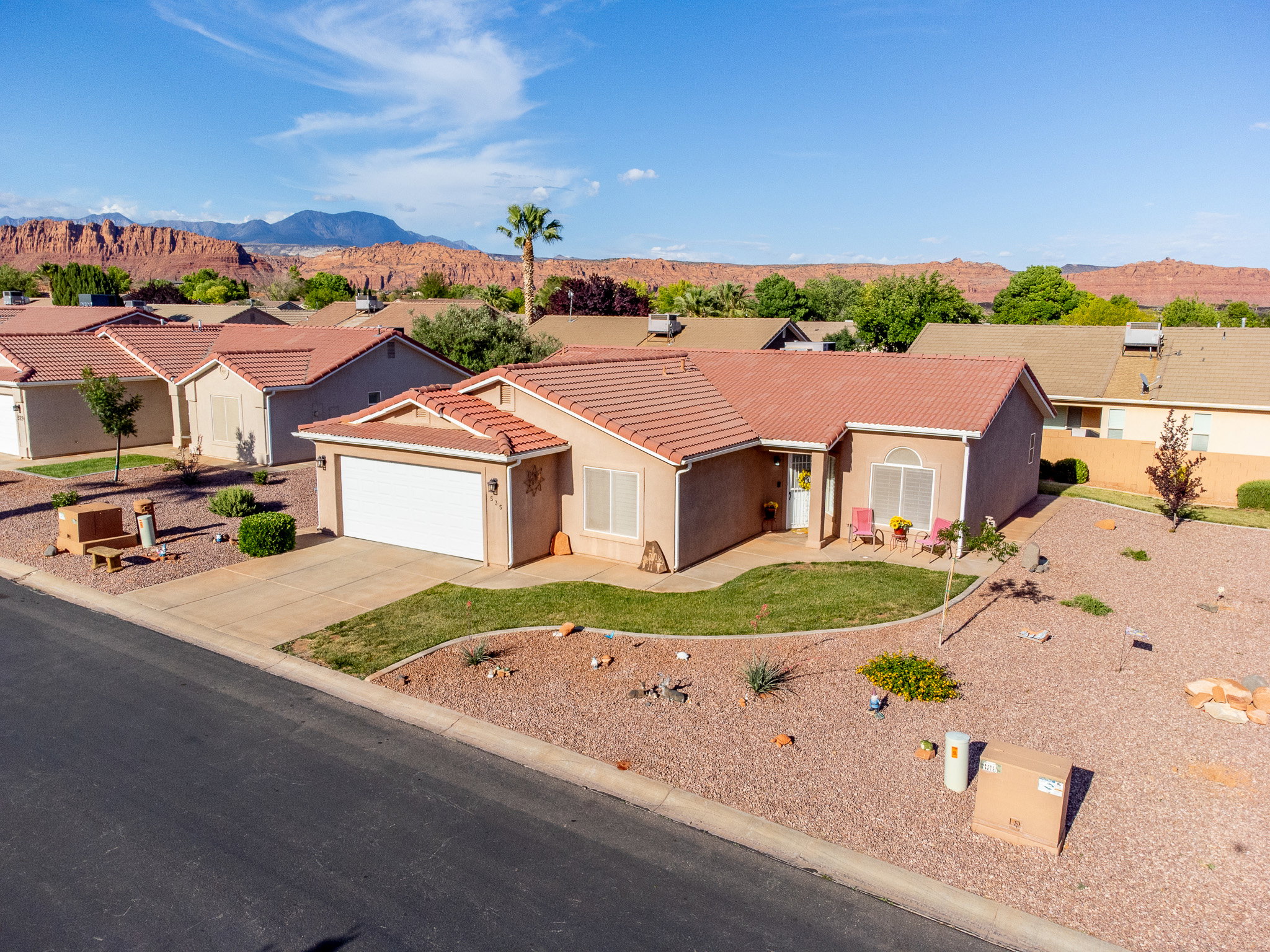 Southwestern-style residence featuring a stucco exterior and a red tile roof