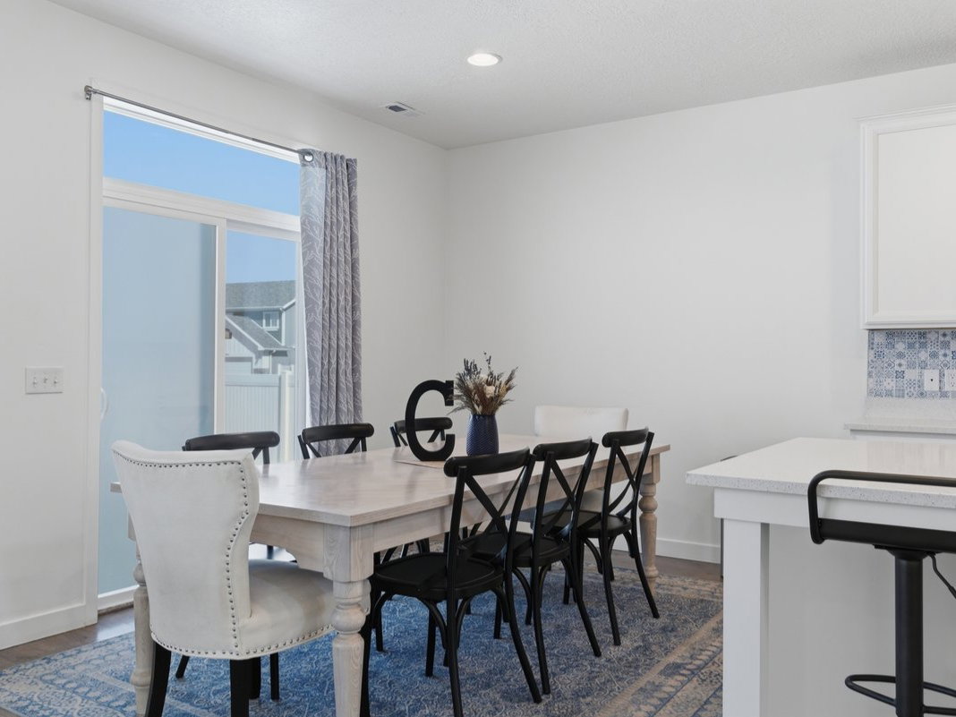 Dining area with wood-finish flooring and a sliding glass door