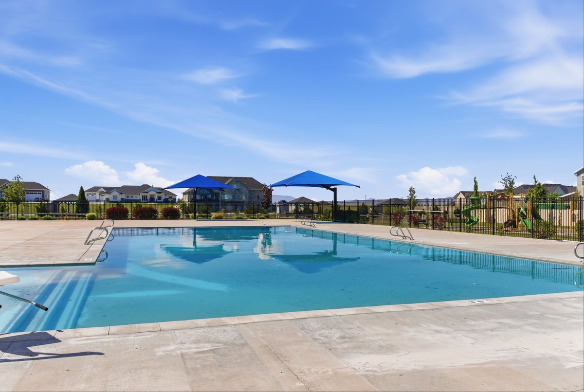 Community swimming pool with concrete decking