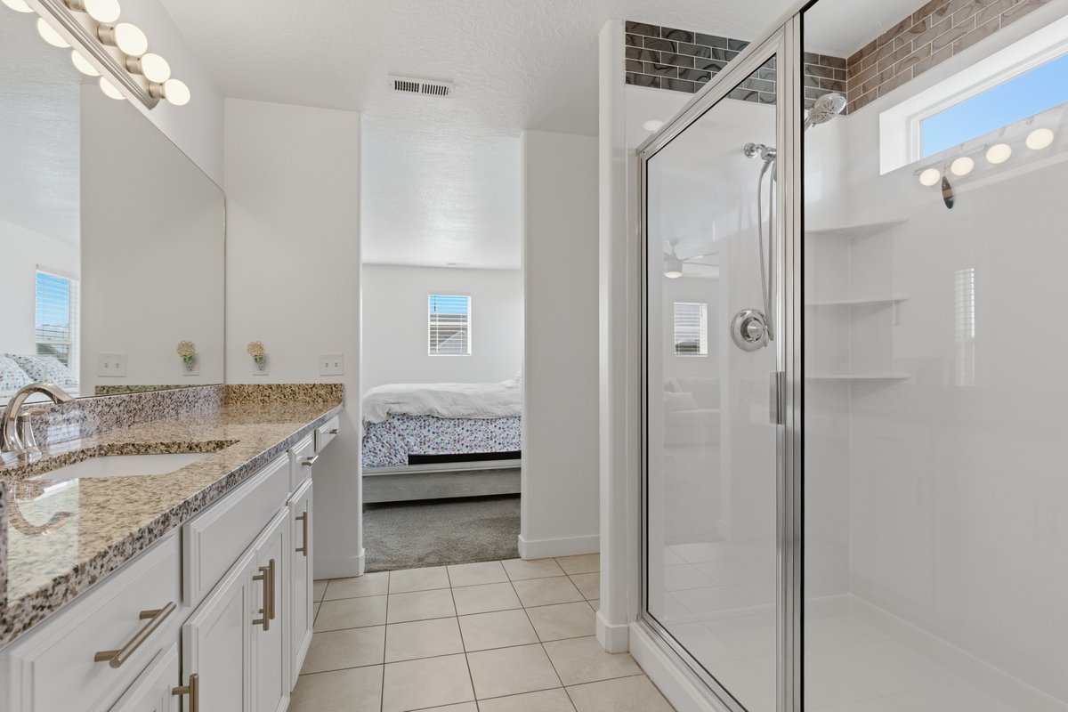 Double vanity with granite-finish countertop, undermount sinks, and chrome fixtures