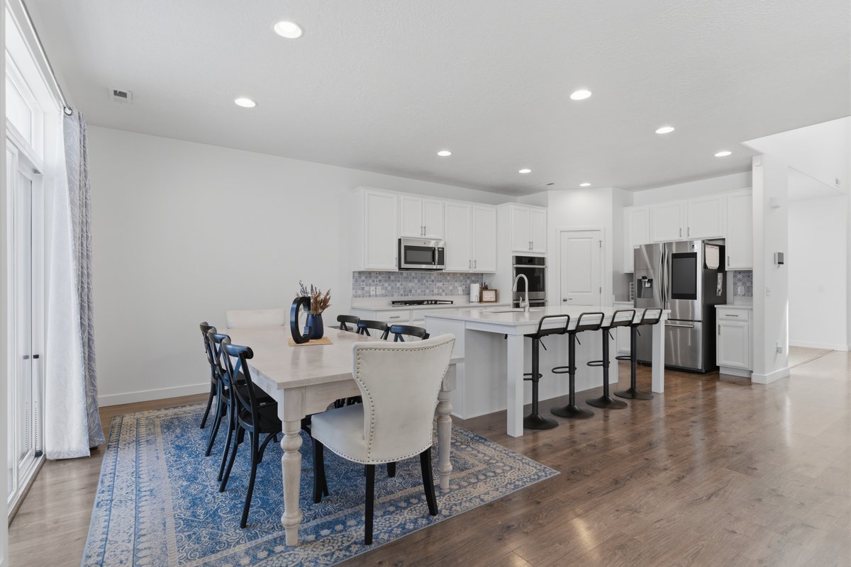 Open-concept kitchen and dining area featuring wood-finish flooring