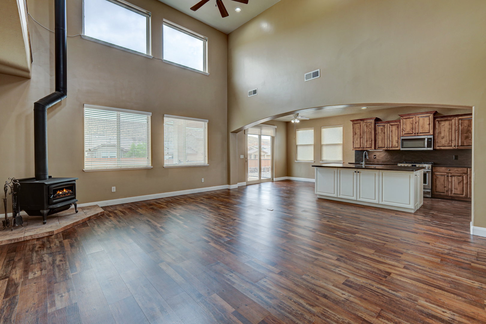 Spacious living area featuring high ceilings and wood-finish flooring