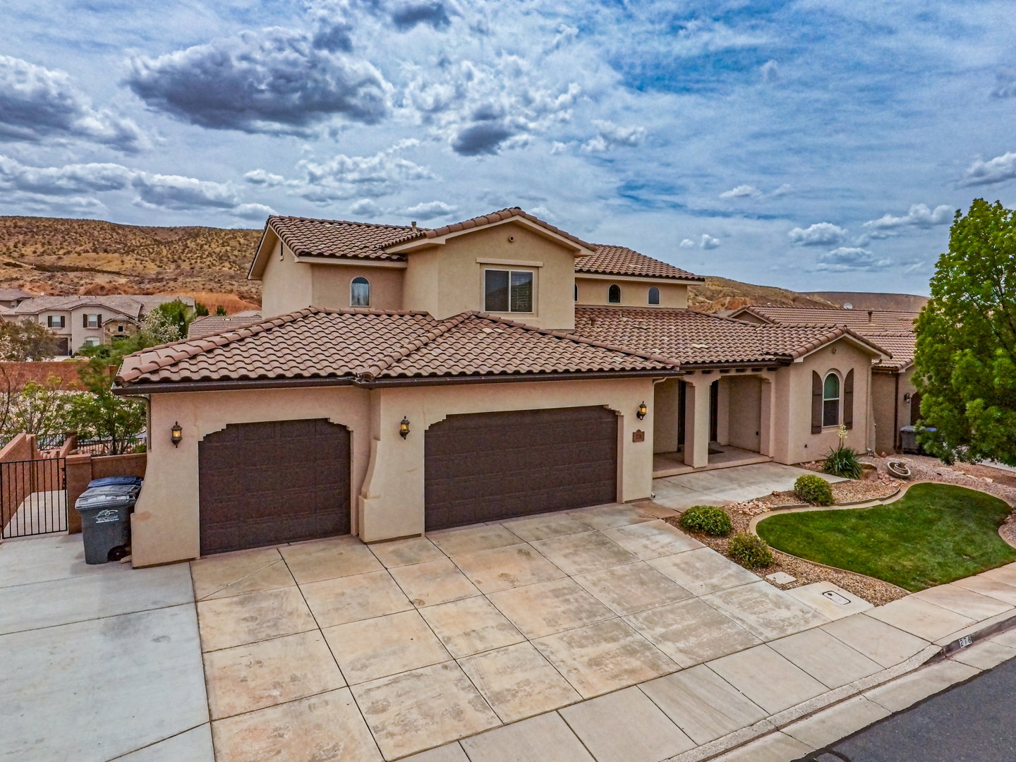 Southwestern-style residence featuring a tile roof and stucco exterior