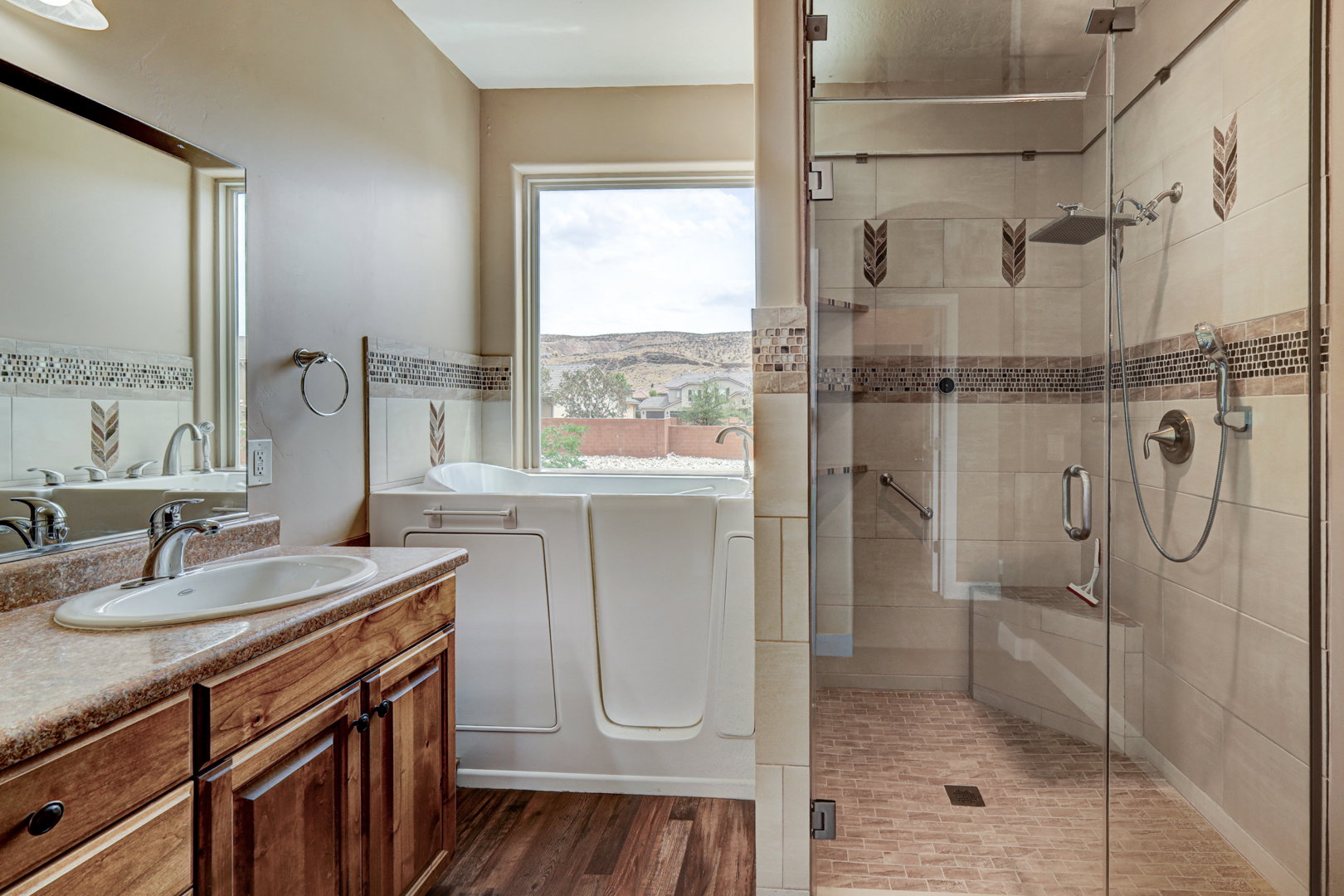 Spacious bathroom featuring a walk-in shower with glass enclosure, a built-in bench, and a rain showerhead