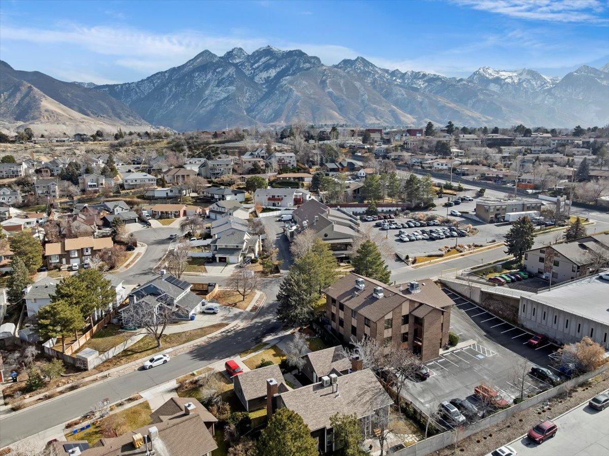 Aerial perspective showcasing a residential neighborhood with a backdrop of snow-capped mountains