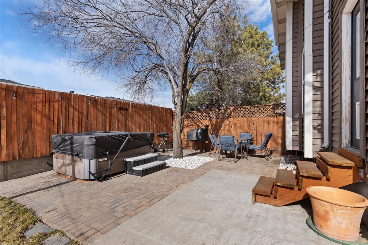 Private patio featuring brick paver and concrete surfaces
