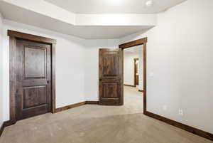 Room featuring light-colored carpeting and white walls