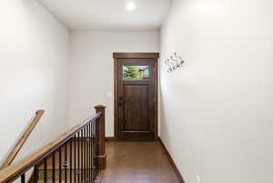 Rich wood-finish entry door with a clear glass insert