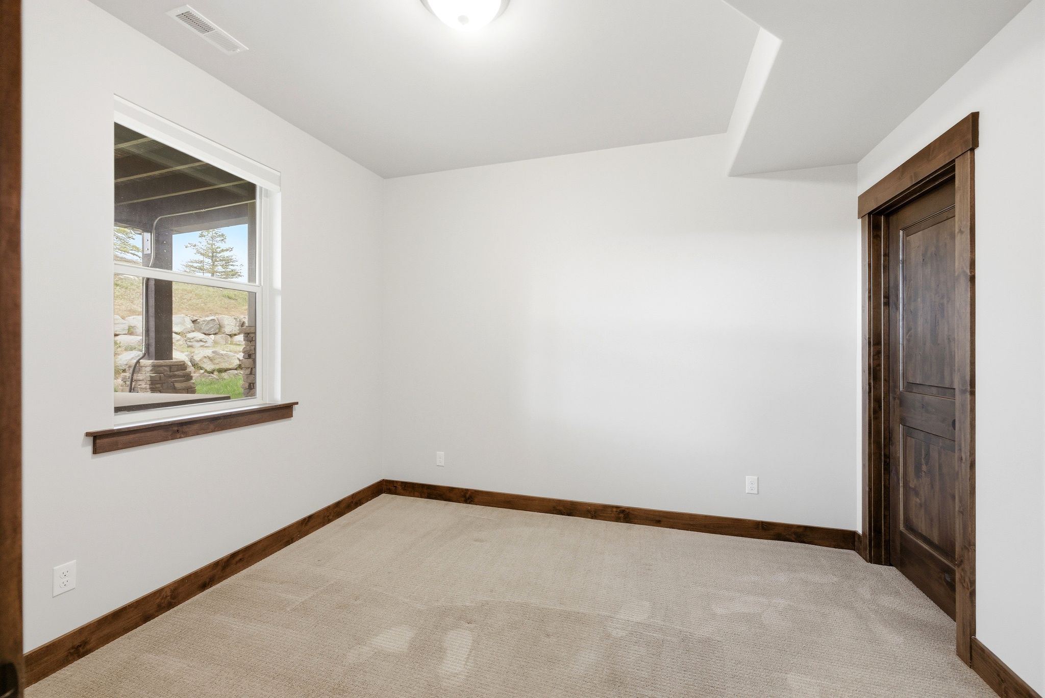 Neutral wall paint with contrasting wood-finish trim and doors