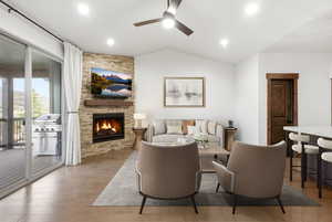 Living area featuring a stone accent wall with an integrated fireplace and wood mantel