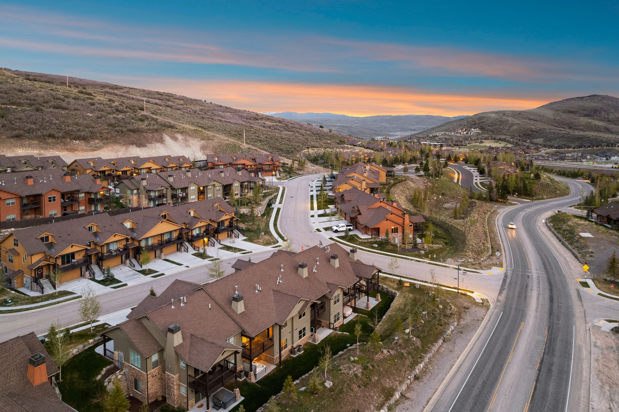 Newly constructed townhomes featuring multi-level designs and covered porches