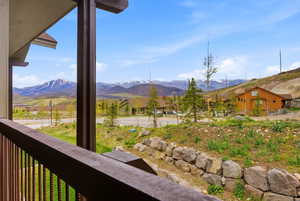 Balcony with wood-finish railing and vertical balusters