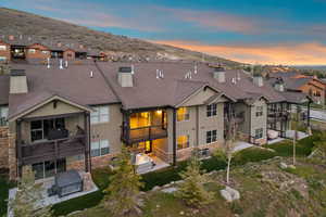 Contemporary multi-story townhome with stone facade accents and multiple private balconies