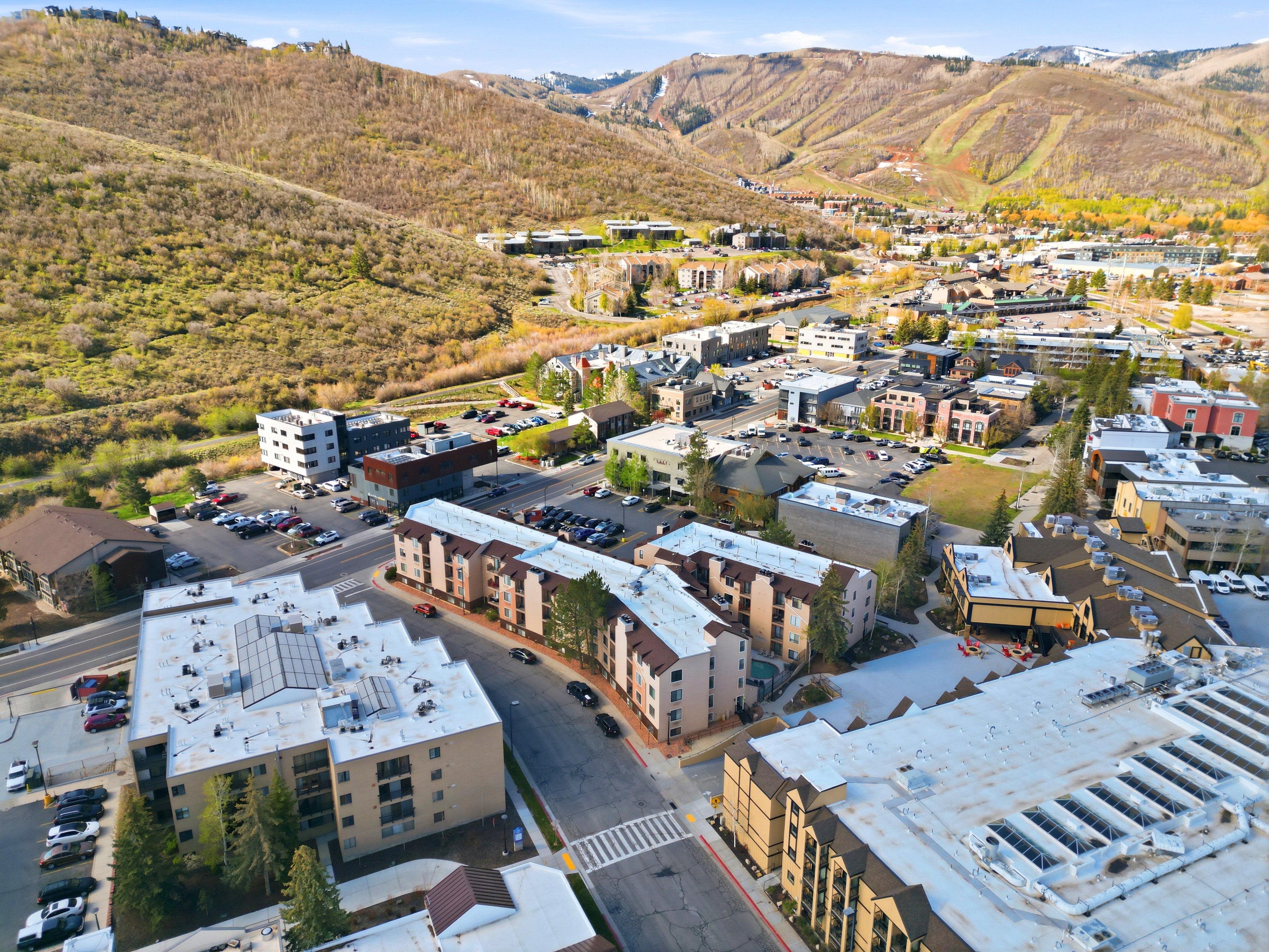 Aerial perspective showcasing a community nestled within a mountainous landscape