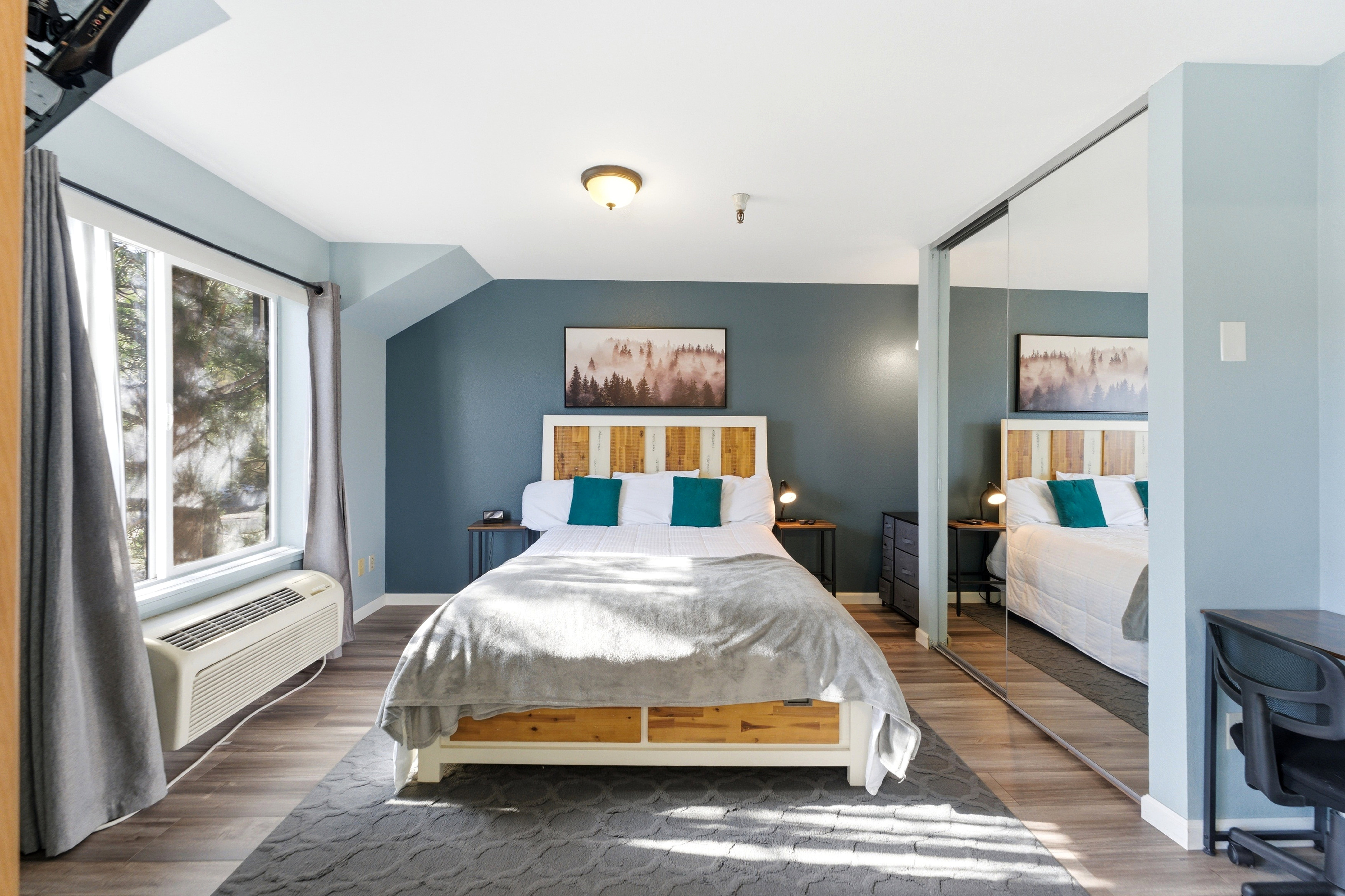 Spacious room featuring wood-finish flooring and a large window