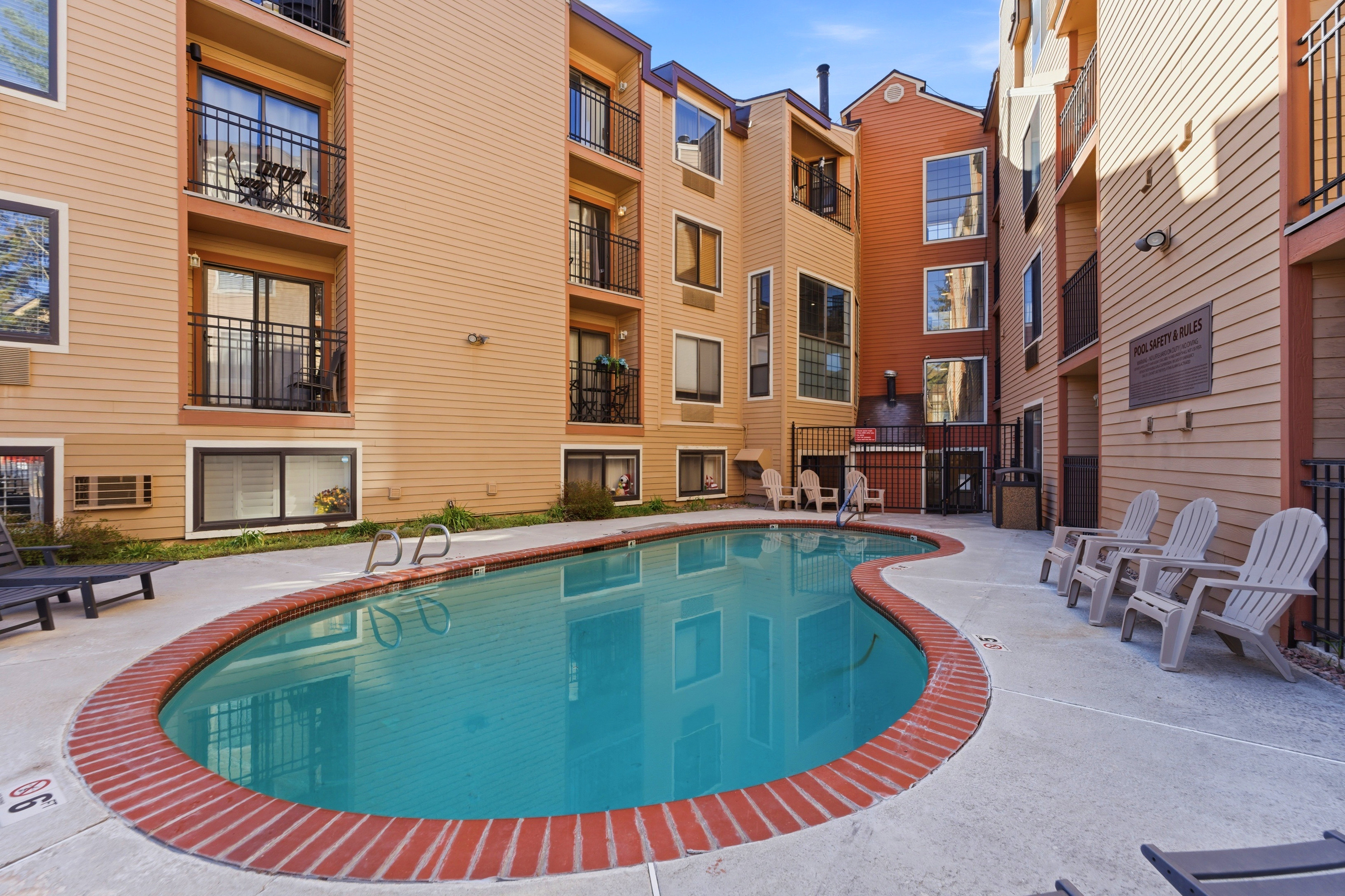 Resort-style pool with brick coping and concrete decking