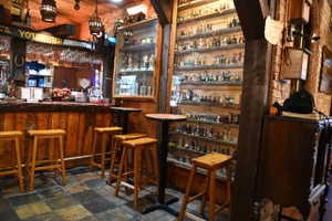 Custom bar area featuring rough-hewn wood paneling and a substantial wooden countertop