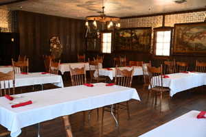Spacious dining area featuring wood-finish flooring and extensive wood paneling