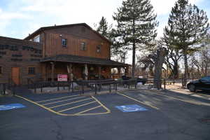 Two-story wood-sided building featuring a covered porch, multiple windows, and a prominent "GENERAL STORE" sign