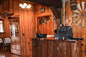 Wood-paneled interior featuring a rustic-style counter with a live-edge wood top