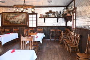 Dining area featuring wood-finish flooring and wainscoting