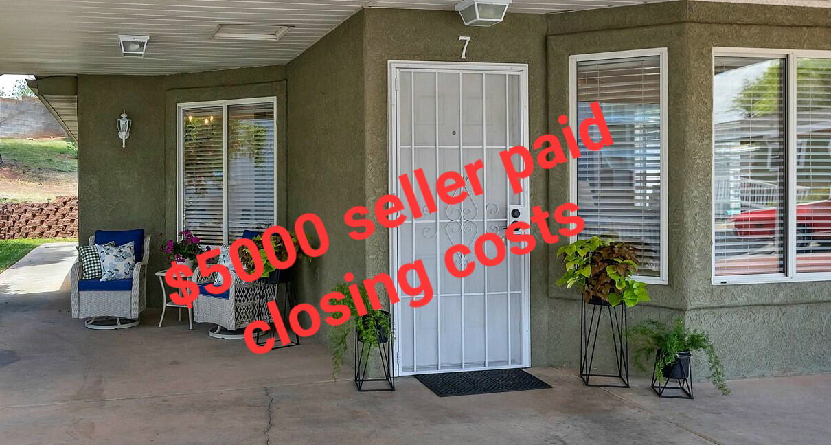 Covered front patio featuring stucco exterior, security screen door, and multiple windows with blinds