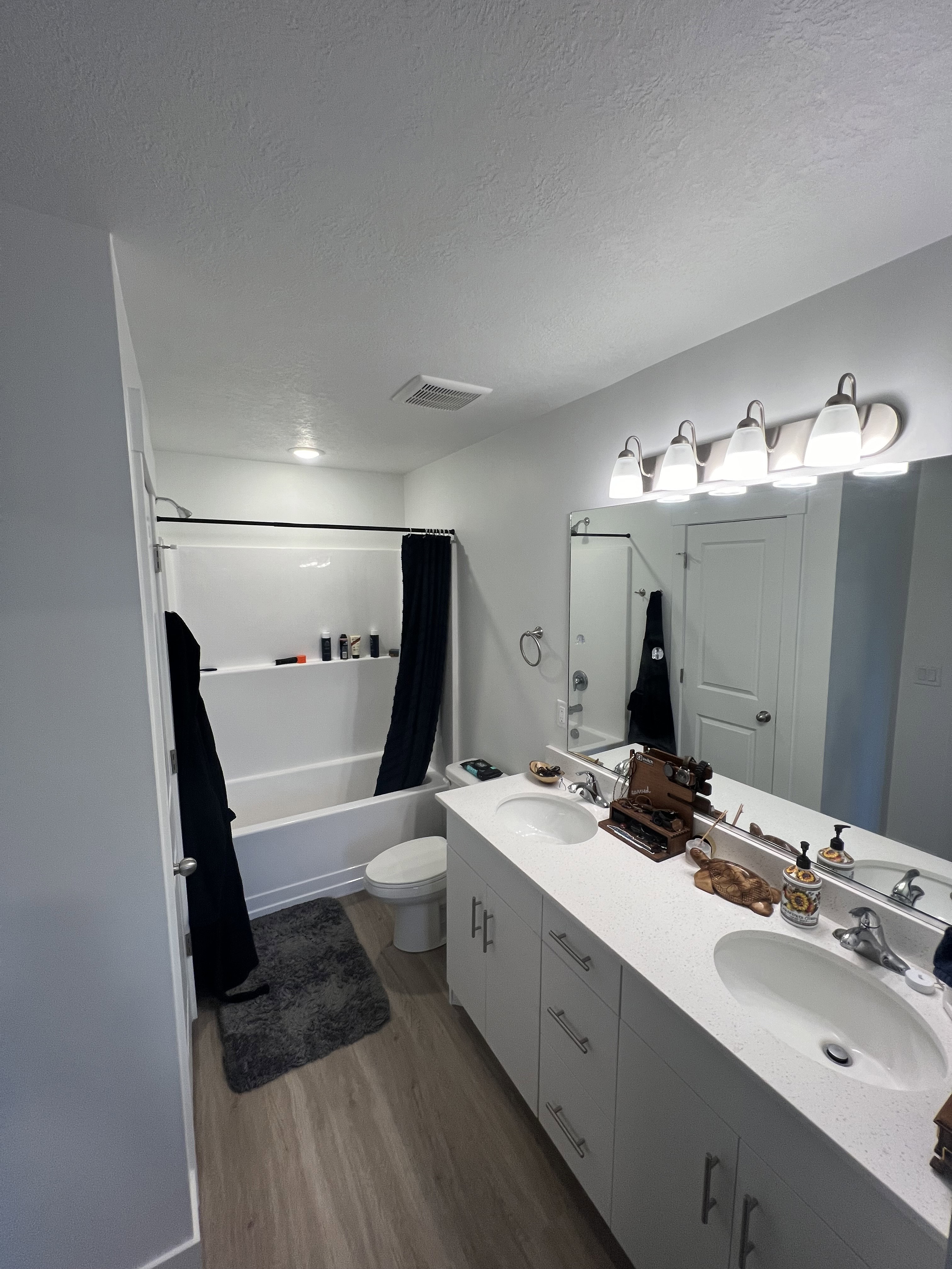 Double vanity with white cabinetry and integrated sinks featuring brushed nickel hardware and fixtures
