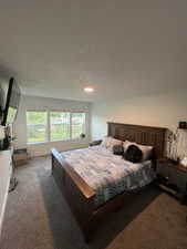 Carpeted room with multiple windows providing natural illumination