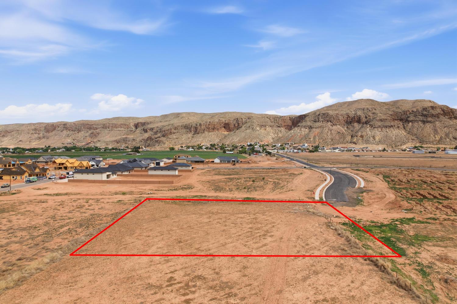 Expansive undeveloped lot with surrounding residential development