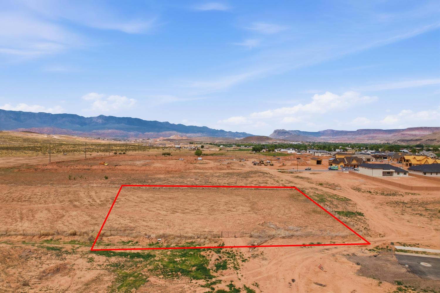 Expansive undeveloped parcel outlined in red, featuring a flat, arid landscape