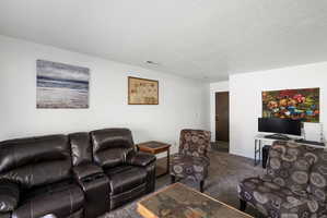 Neutral wall finishes complement the textured carpeting